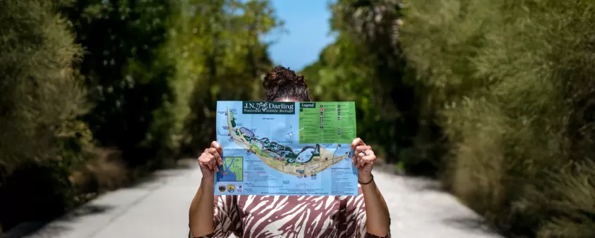 Woman holding map of J.N. "Ding" Darling National Wildlife Refuge